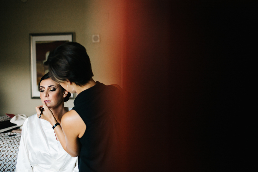 Bride getting her makeup done with smokey eye and nude lip