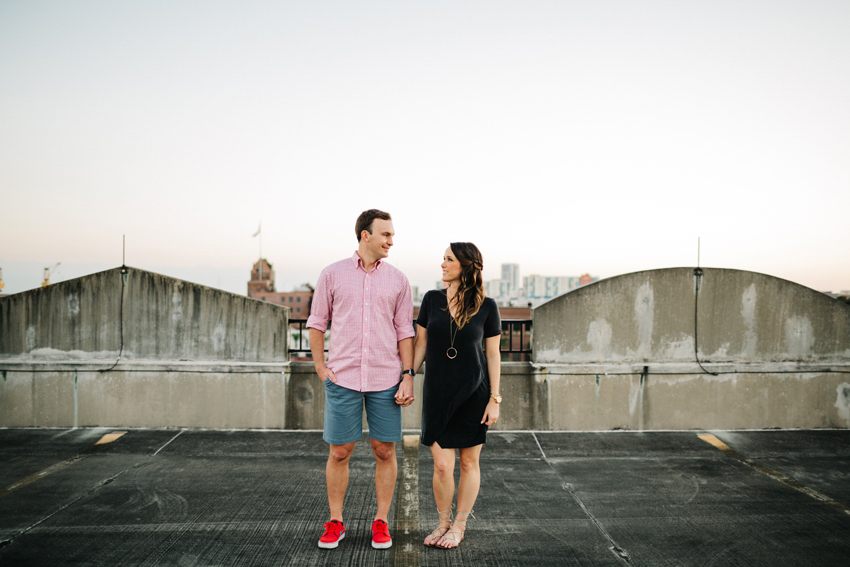 Engagement photos on the rooftop of a parking garage in Ybor City with the Tampa skyline in the distance