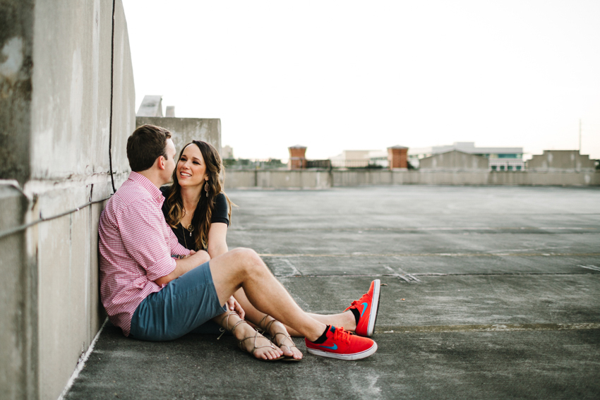 Cute couple sitting in a parking garage during their engagement session