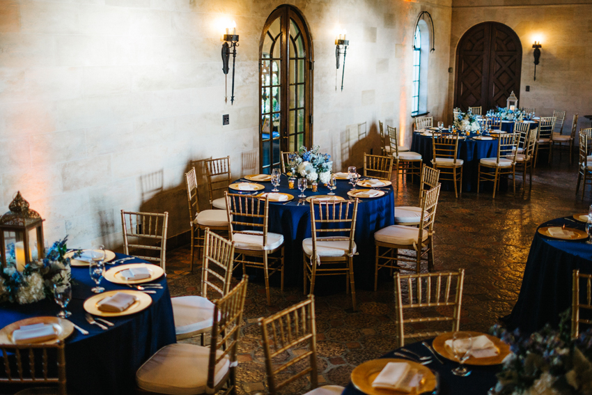 Navy and gold wedding reception details inside a historic mansion