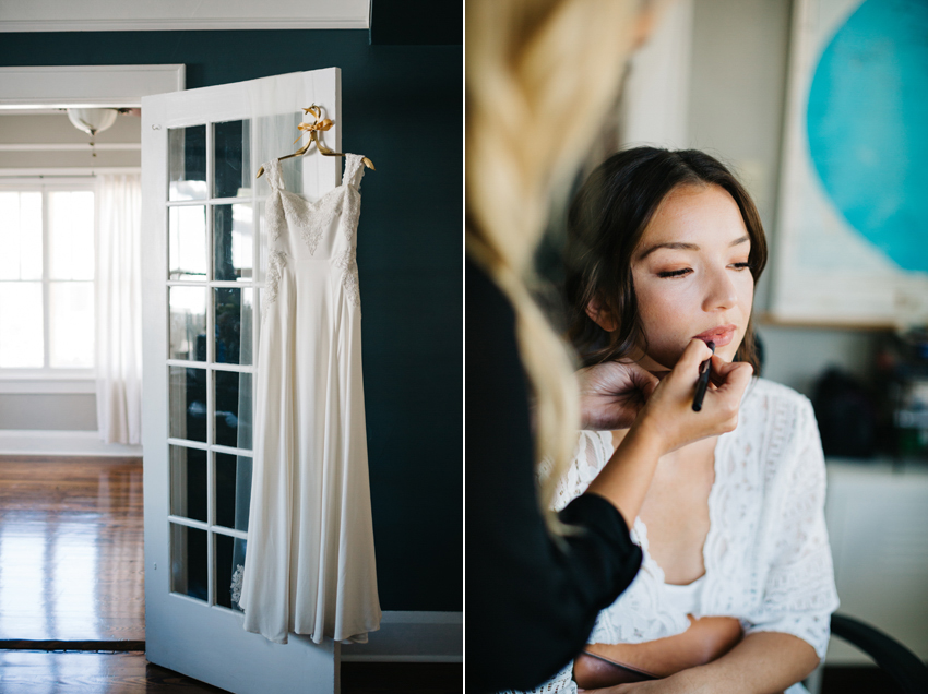 bride getting ready in front of the window with natural light