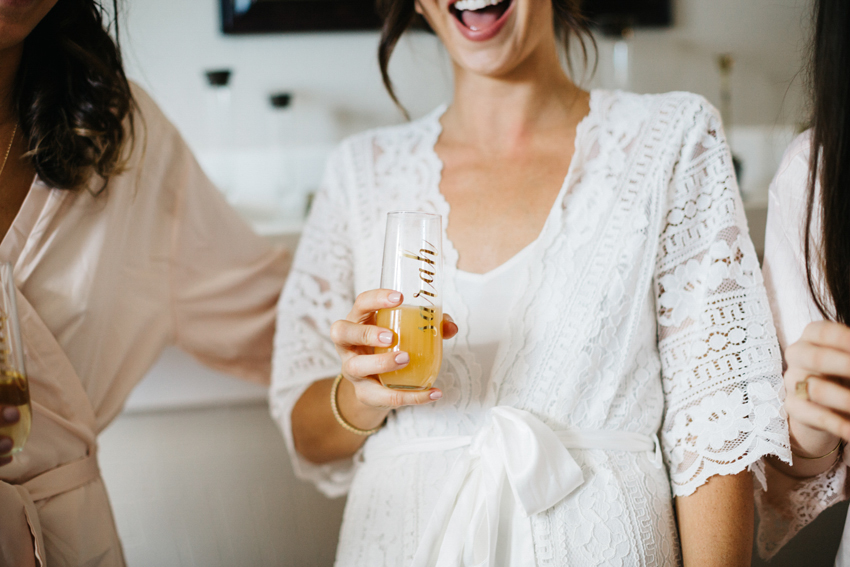 bride drinking a mimosa in a personalizes gass with gold lettering