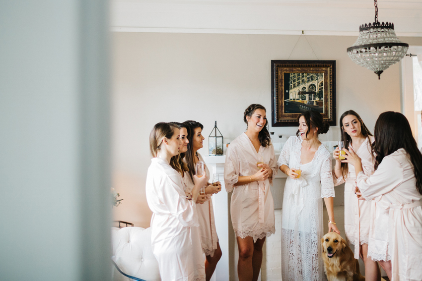 candid photography of bride getting ready with her bridesmaids