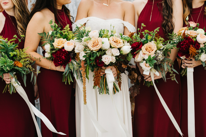 Lush bridesmaid wedding bouquets with burgundy peonies and garden roses