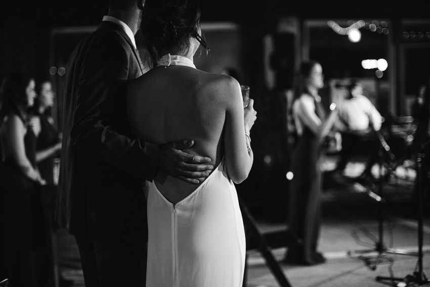 Black and white photos of the newlyweds snuggling during the wedding reception