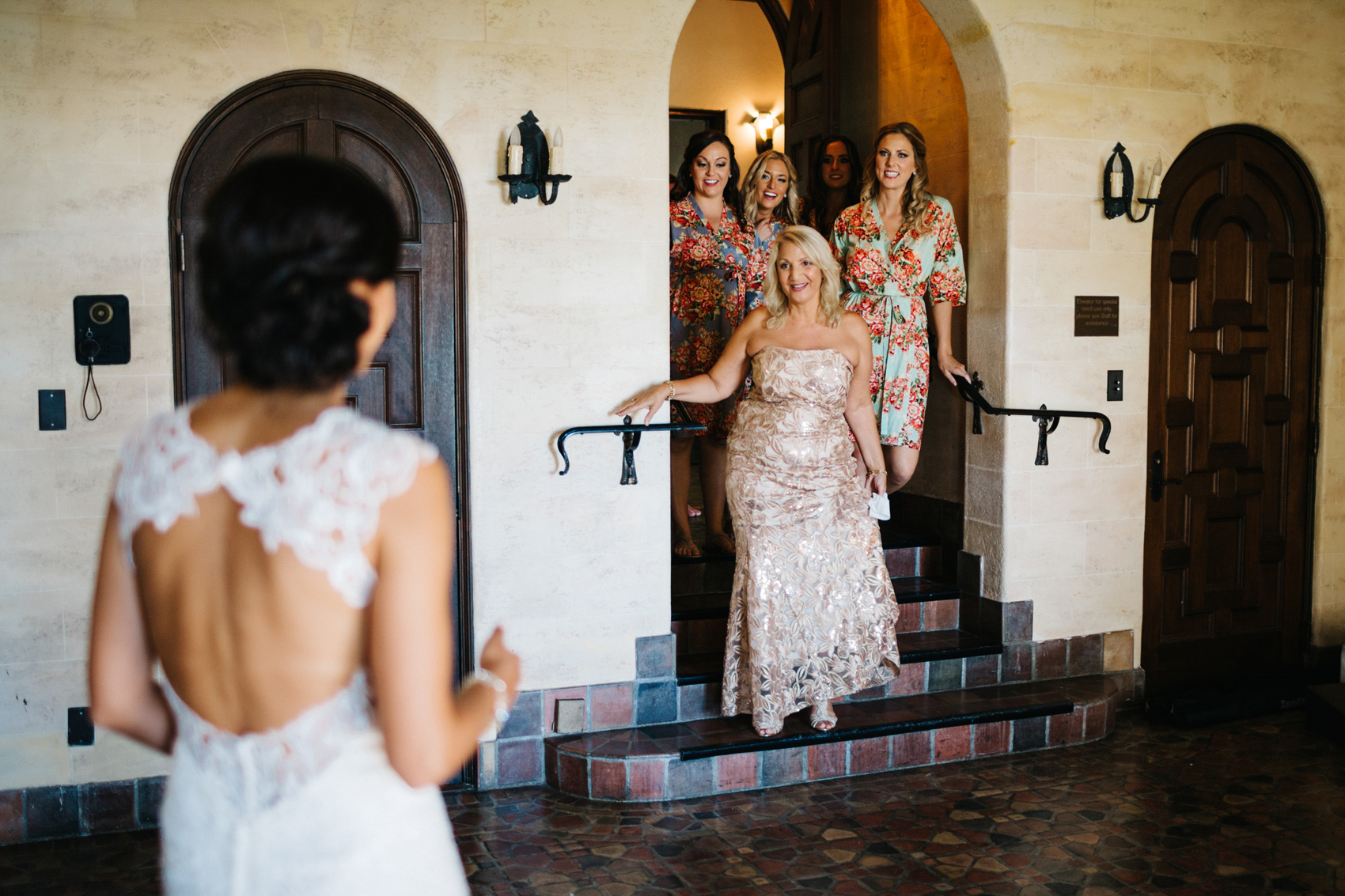 First look with the bridesmaids and mother of the bride wearing floral silk robes