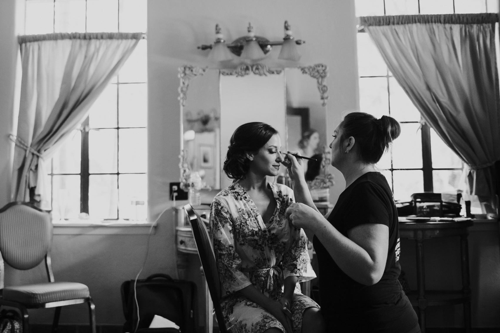 Bride getting her makeup done inside the bridal suite at the Powel Crosley Estate