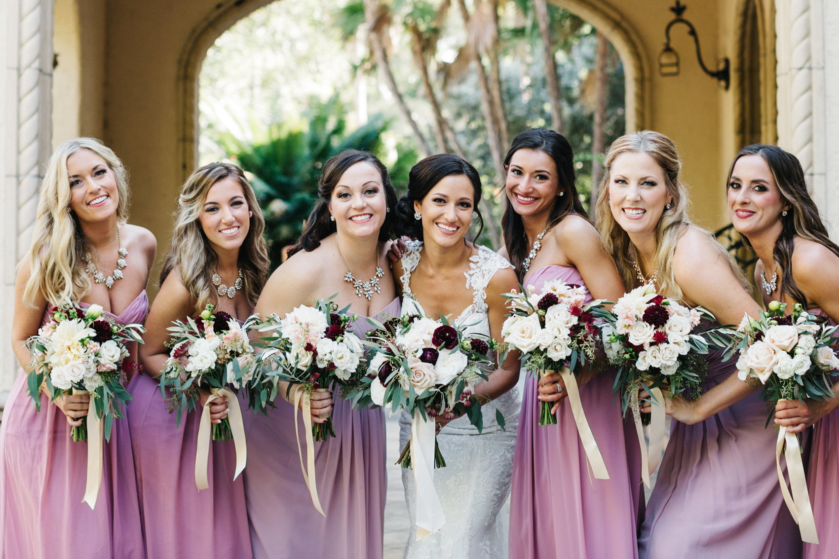 Bridesmaids wearing pink and muave dresses