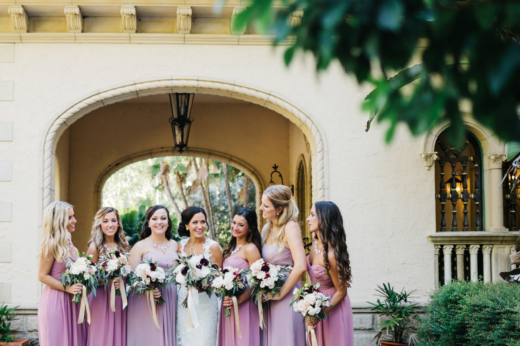 Candid photo of the bride laughing with her bridesmaids