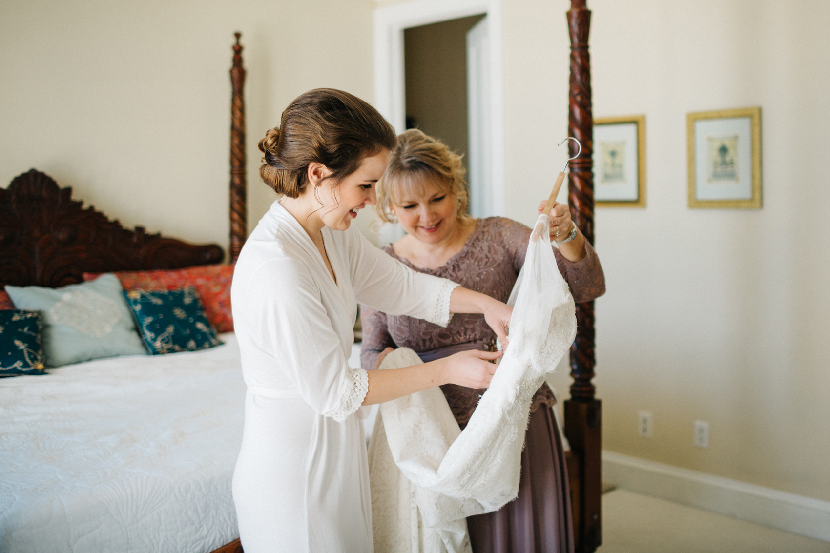bride getting ready to put her wedding dress on with her mom for Vero Beach wedding ceremony