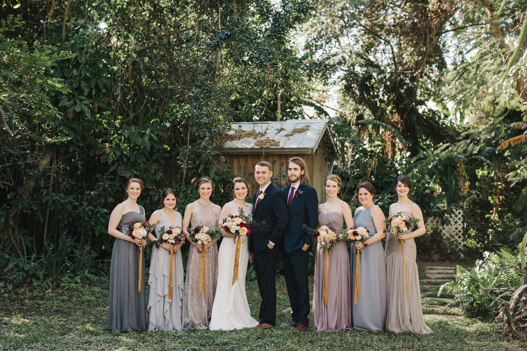 Mismatched bridal party wearing greys and lavendar