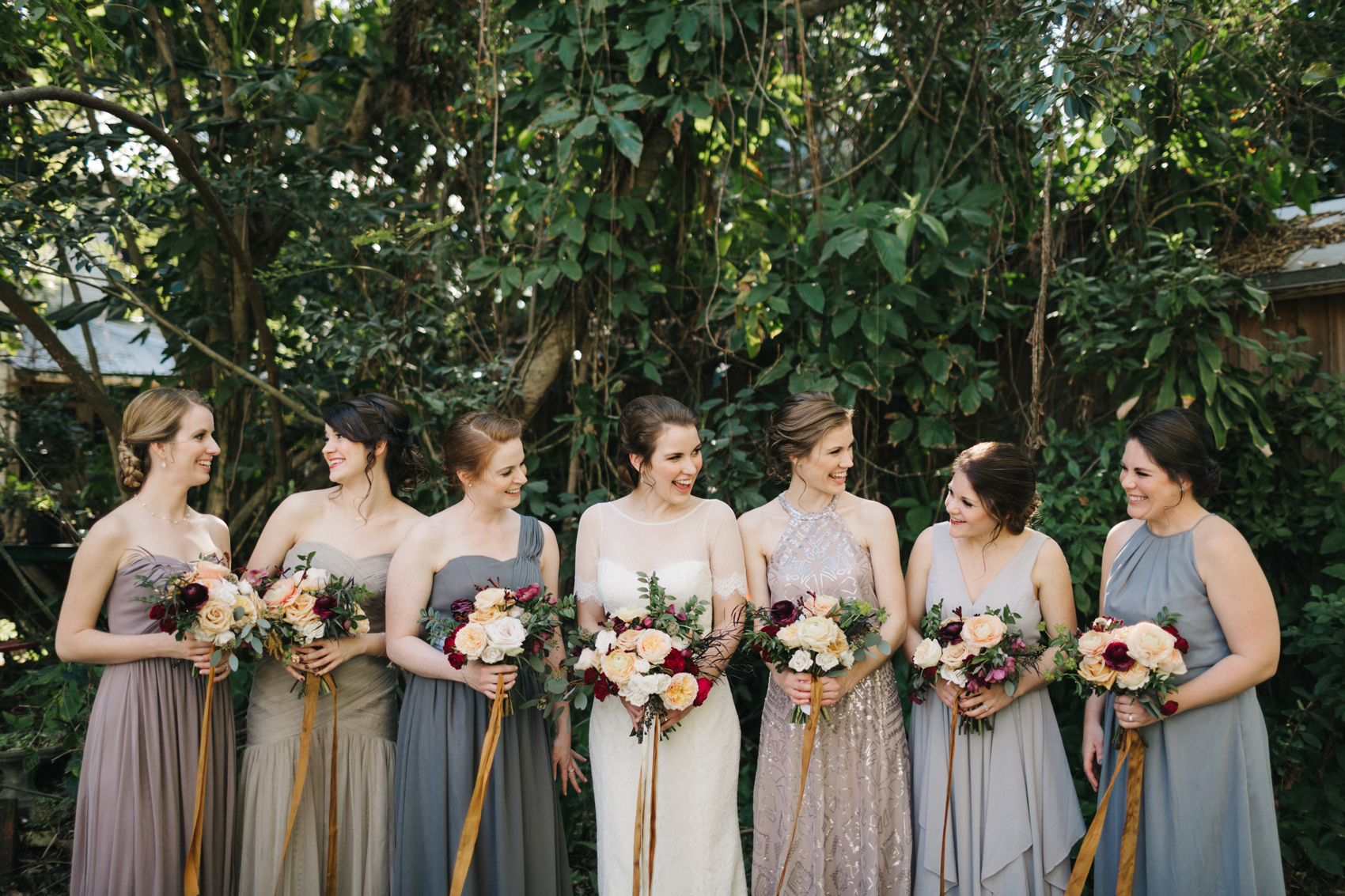 candid photo of the bride laughing with her bridesmaids in the garden before the ceremony at Waldo's Secret Garden