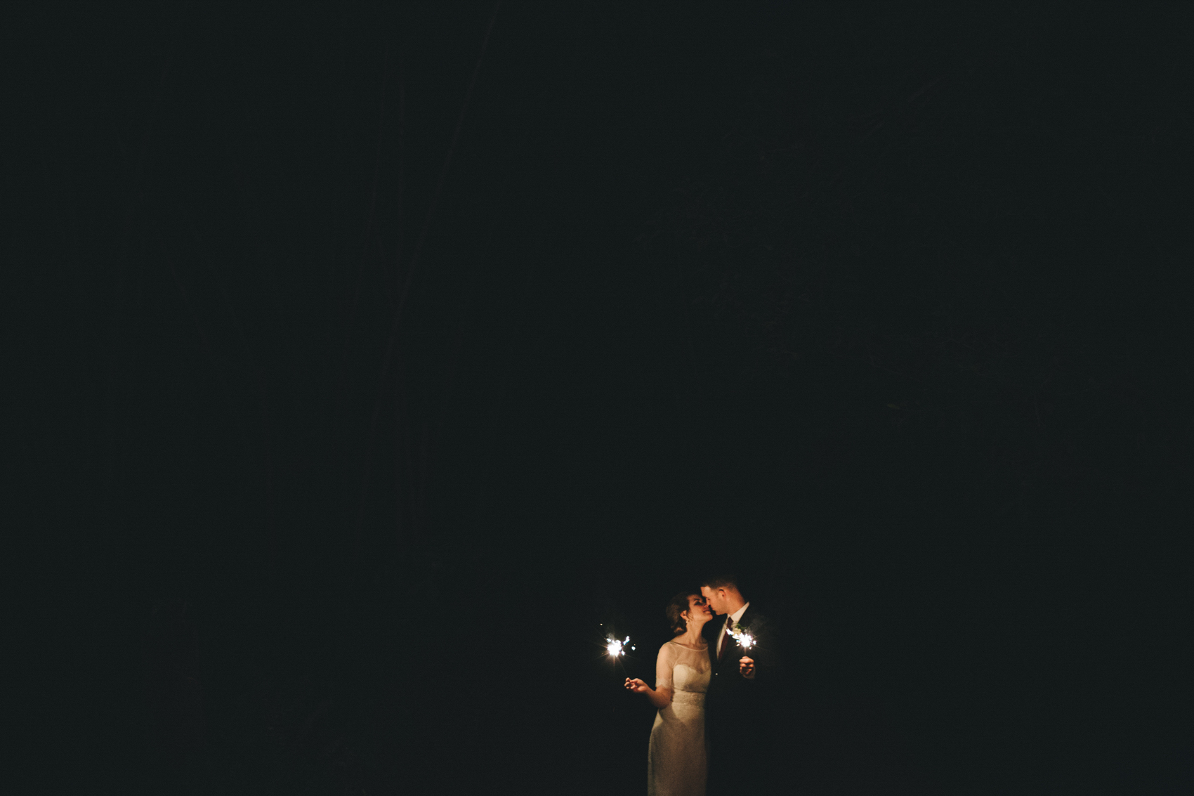 romantic wedding sparkler photo with the bride and groom