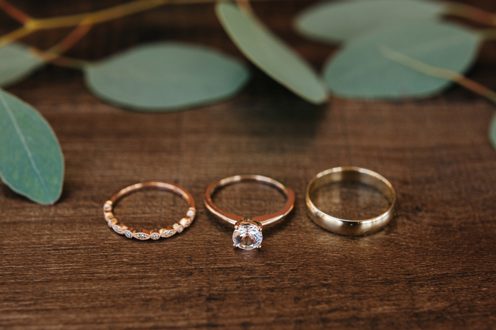 rose gold wedding rings with greenery