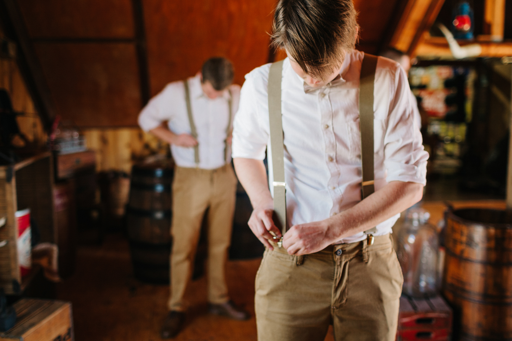 groom putting on suspenders