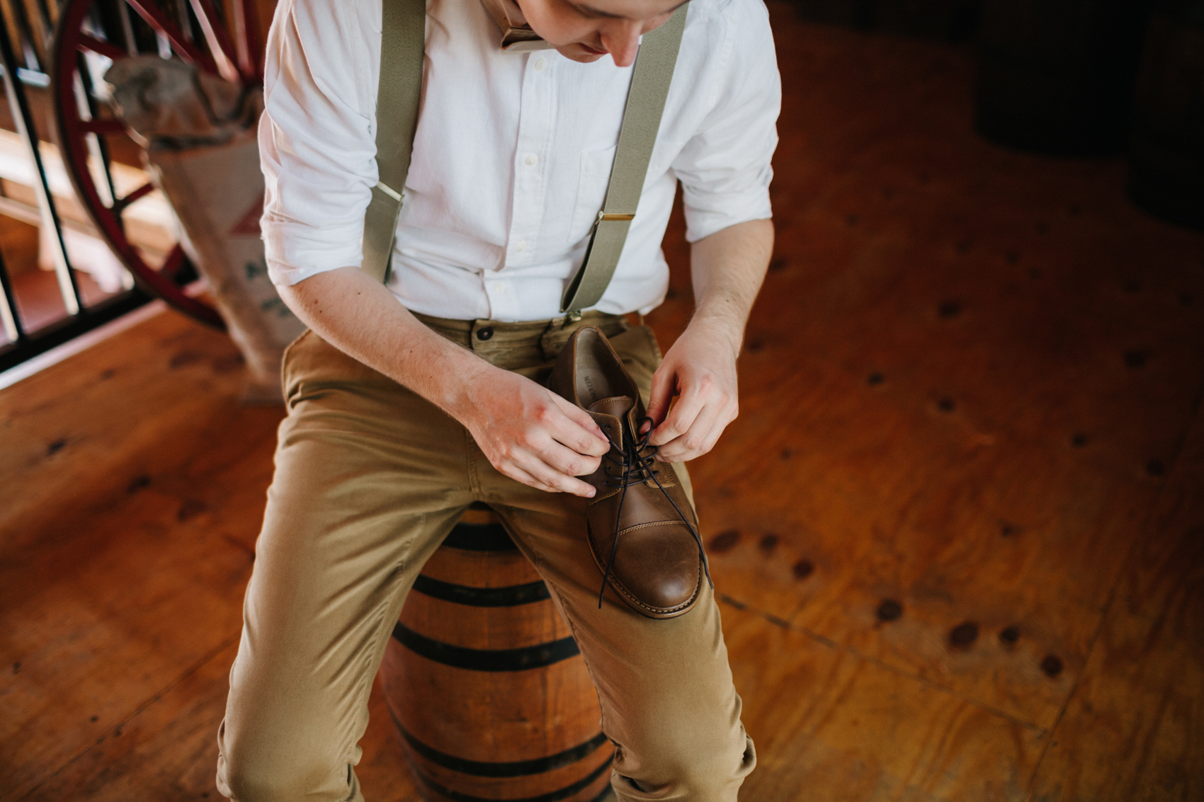 groom lacing up brown shoes