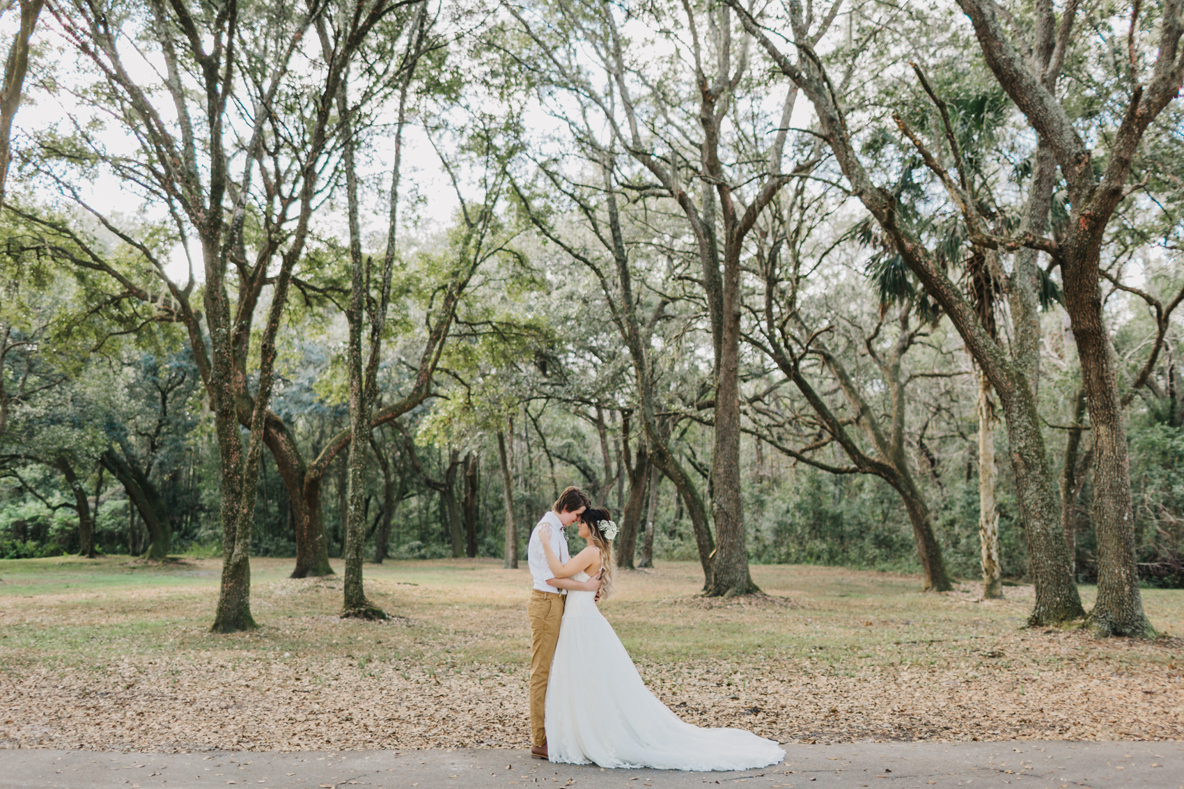 rustic wedding photography in along the beautiful oak trees at the Lange Farm barn wedding venue in Dade City, Florida