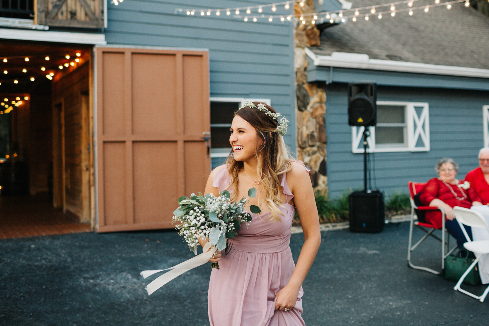 bridesmaid wearing a dusty pink dress and wearing a flower crown for outdoor rustic wedding in Tampa