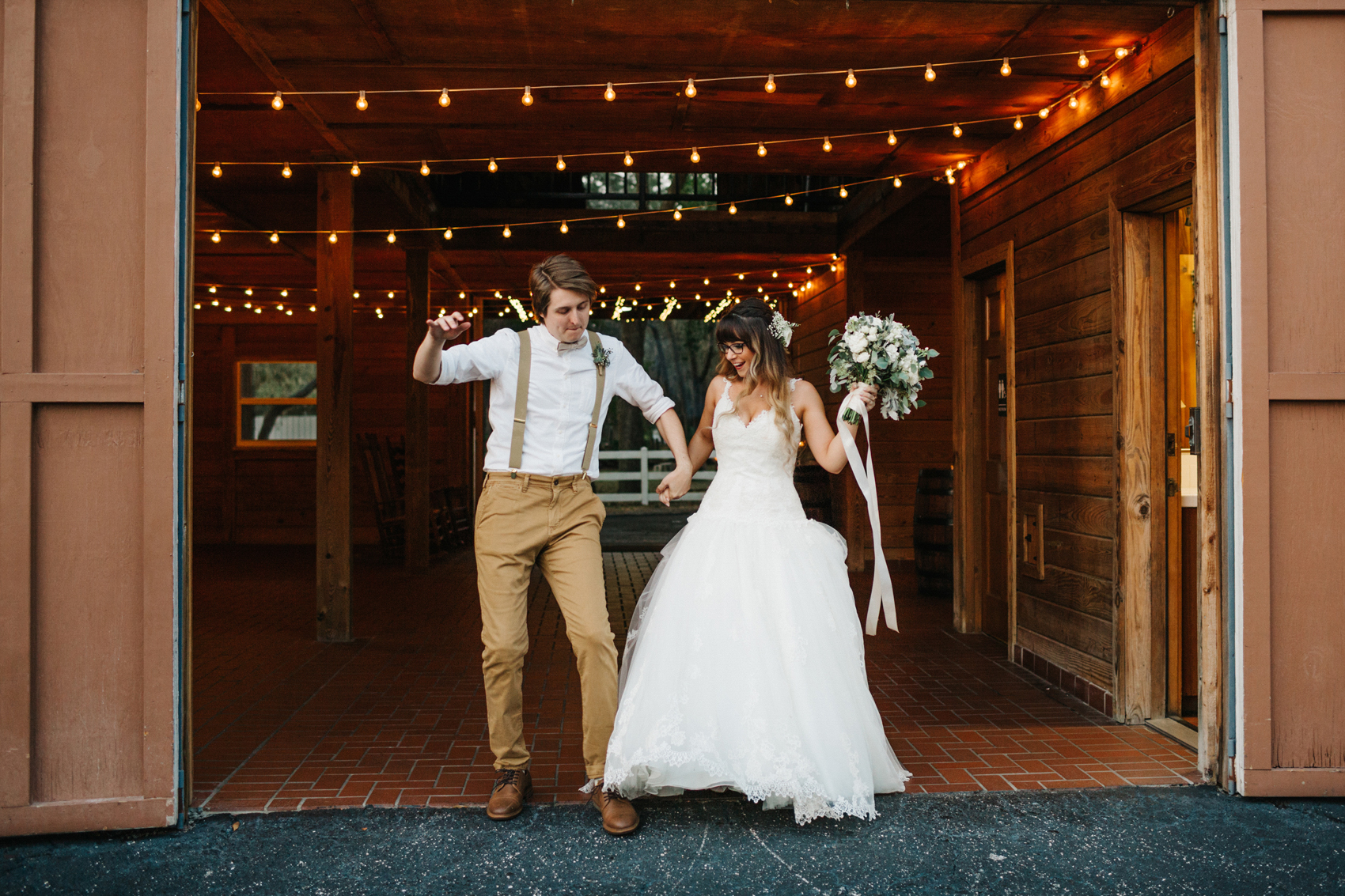 bride and groom dancing as the make their grand entrance at their barn wedding reception in Florida
