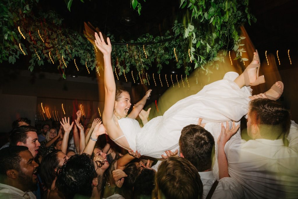 bride crowd surfing and dancing at haus 820 wedding with dj cory barron