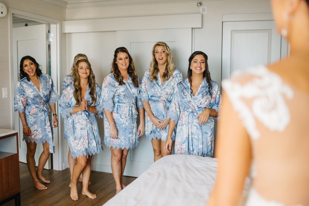 first look with bridesmaids in their dusty blue robes