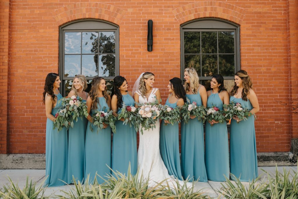 bride and bridesmaids outside of Armature Works for industrial tampa wedding