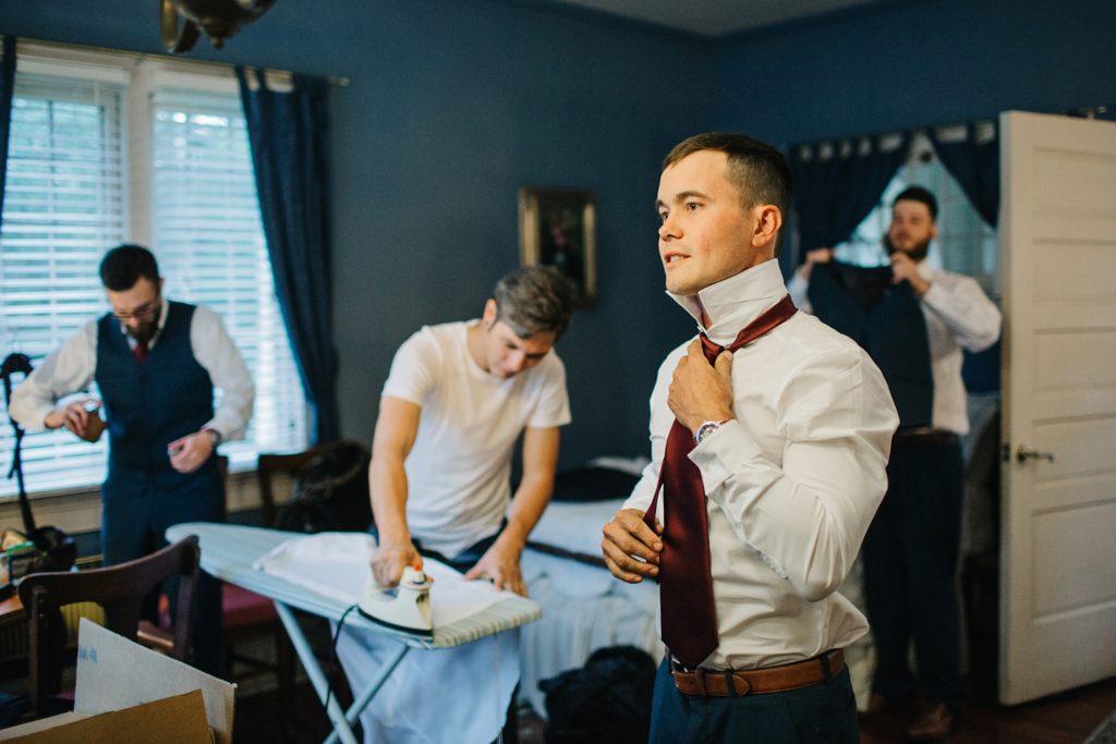 candid photos of the groom getting ready 