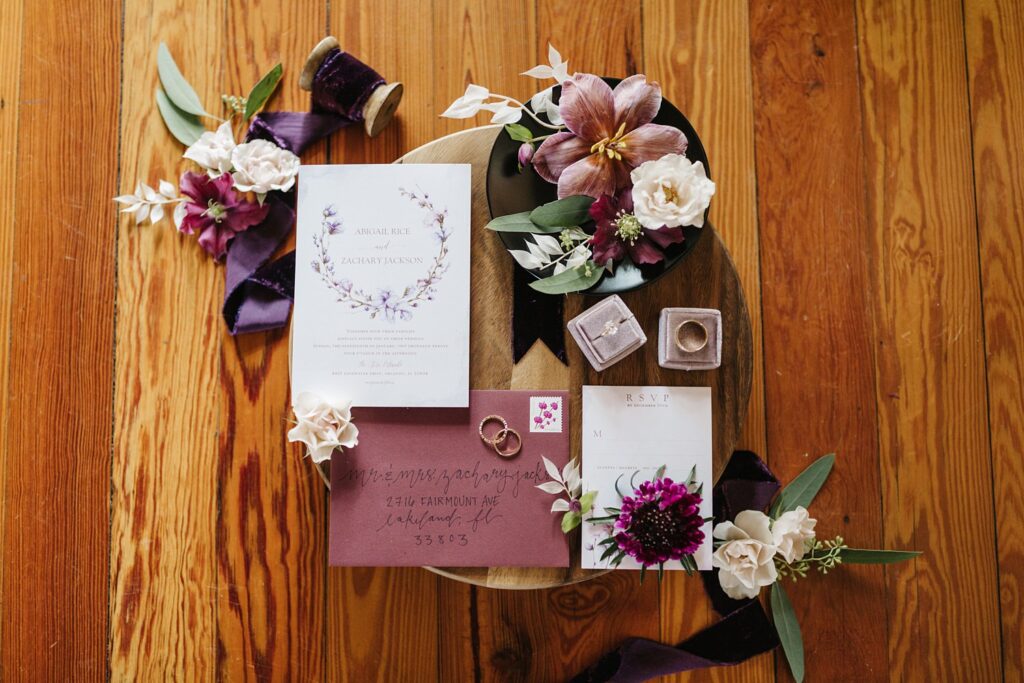 purple and plum styled wedding flatlay