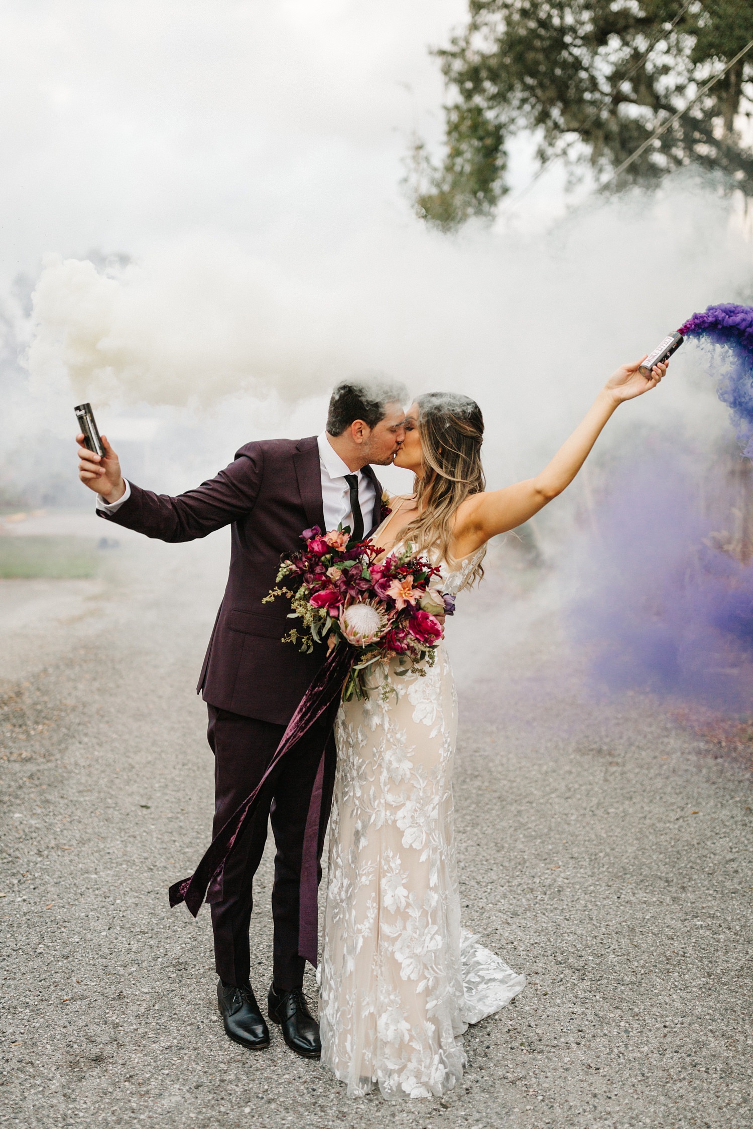 Florida wedding photography at The Acre with bride and groom holding smoke bombs