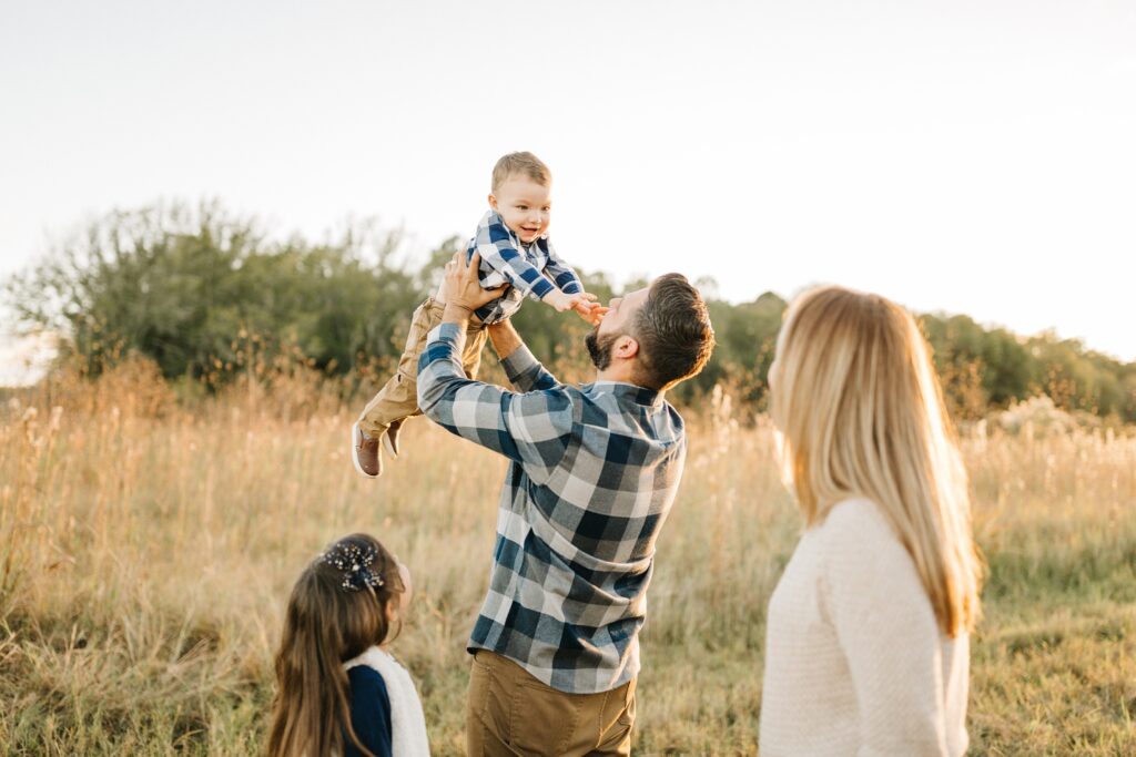 Candid family photos in a field by Land O Lakes Florida family photographer