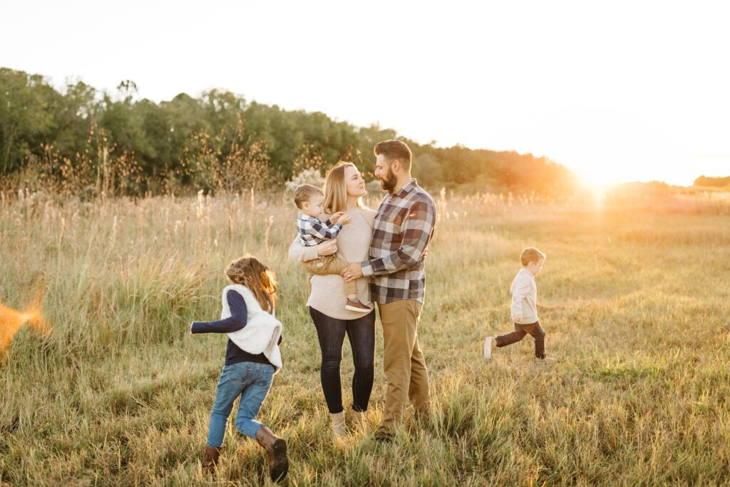 Land O Lakes lifestyle family photos in a field at sunset