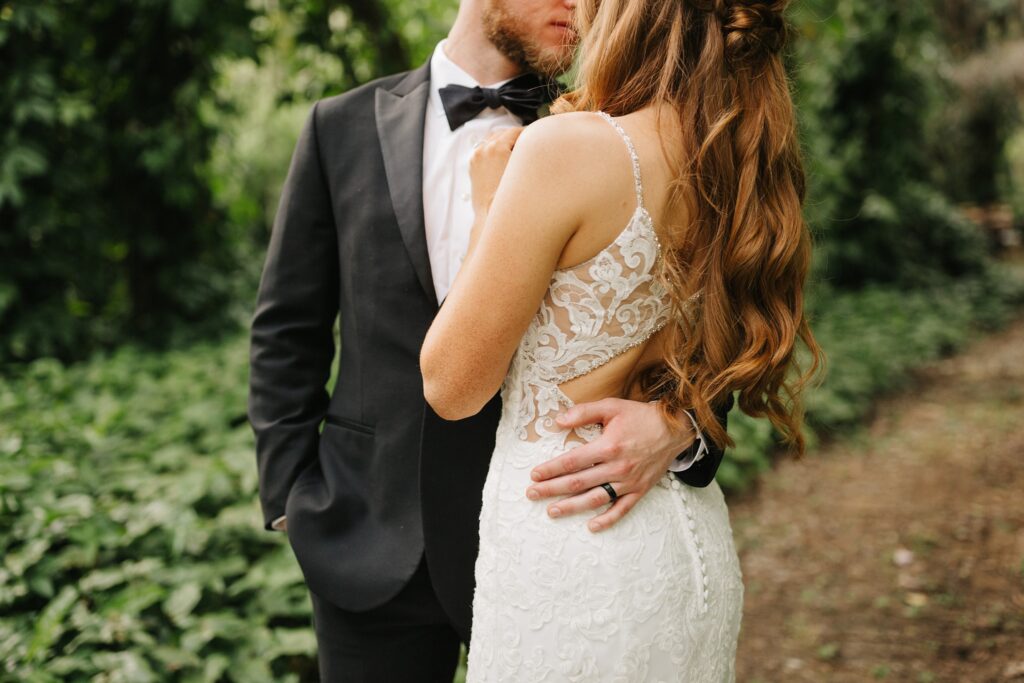Newlywed photos in the woods with lush greenery