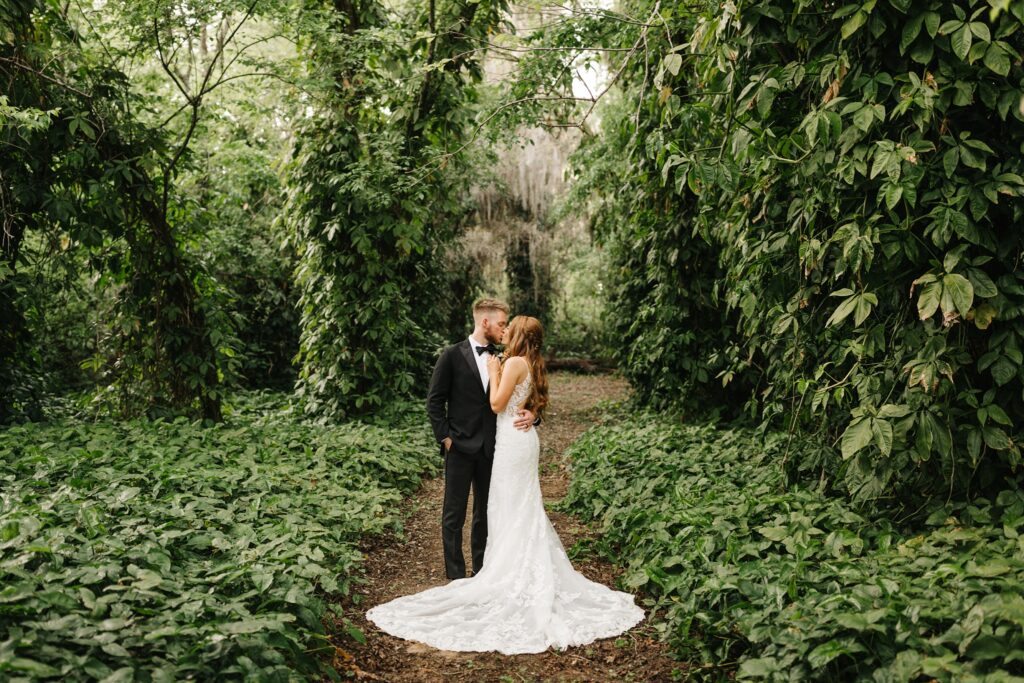 Newlywed photos in the woods with lush greenery at The Mulberry