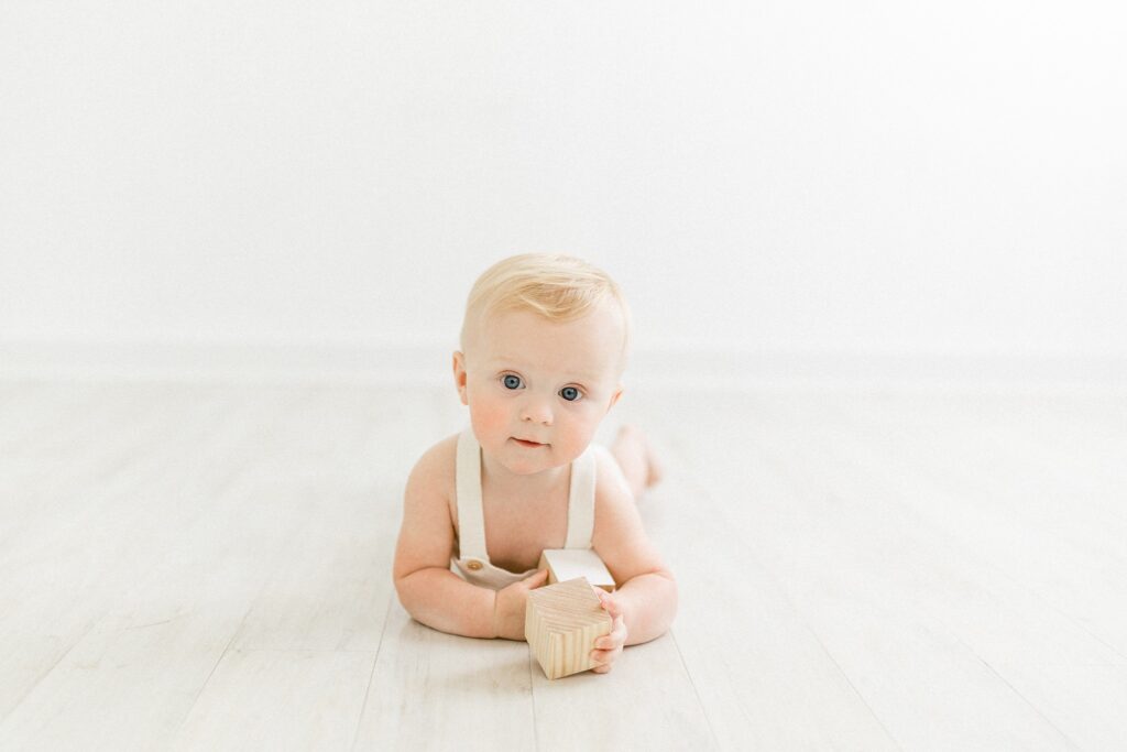 Baby playing with blocks in all white studio in Tampa