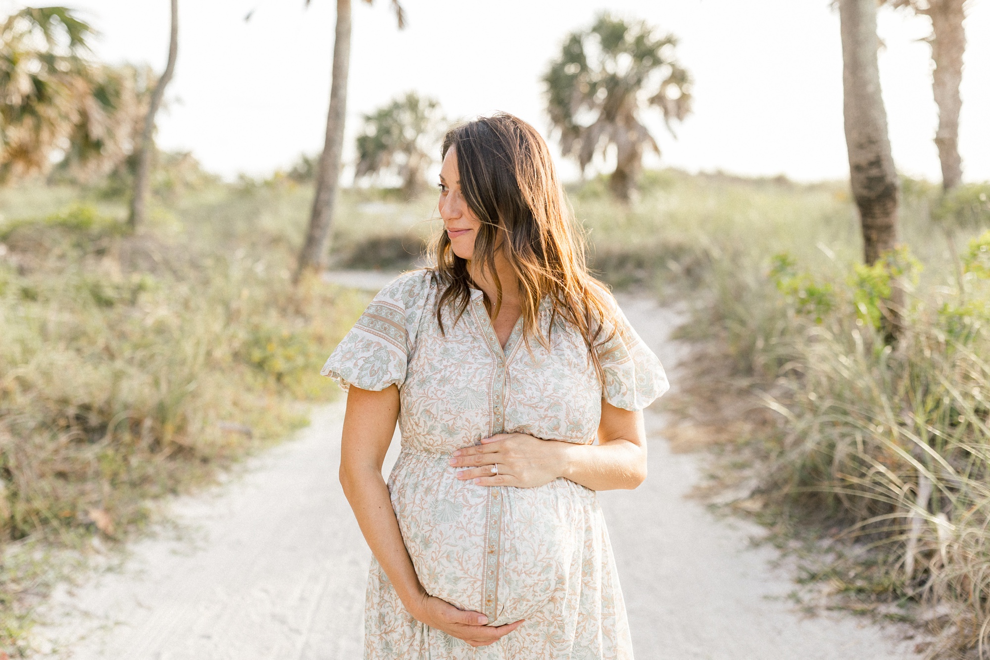 pregnant mom taking maternity photos on the beach